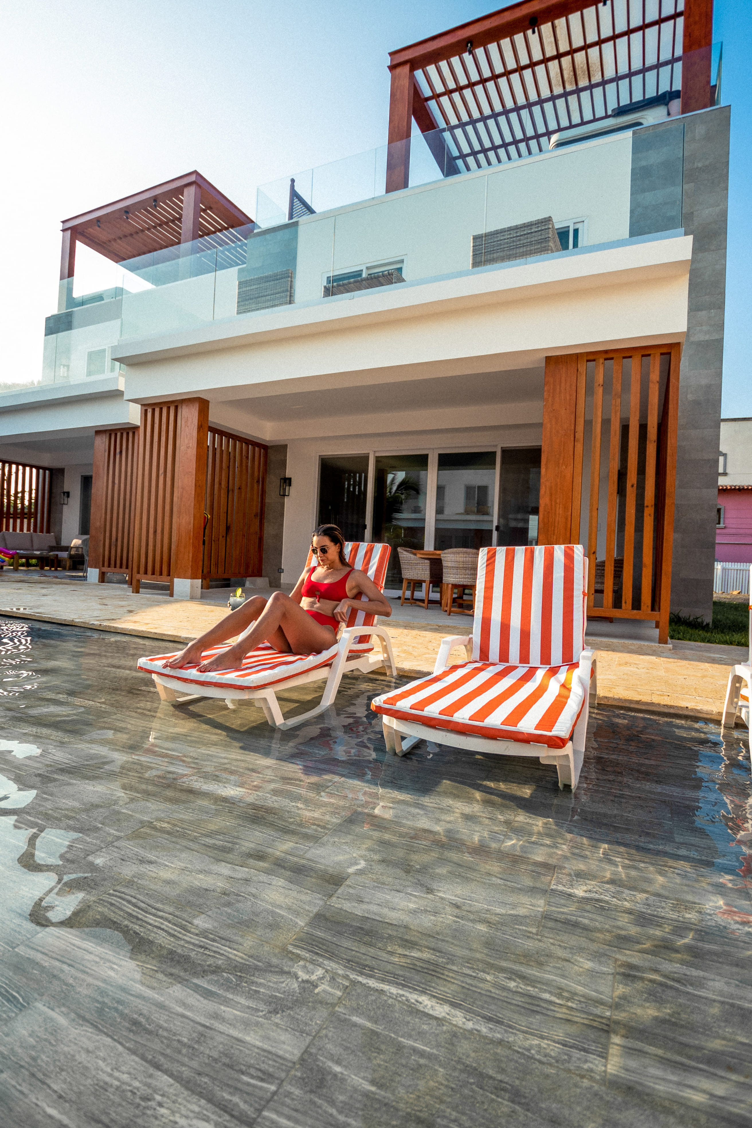 Women seating on a beach chair outside her room